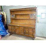 A contemporary Oak Sideboard having a central flight of four drawers with loop handles and flanked