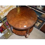 A walnut finished two tier circular Occasional Table standing on cabriole legs with ball and claw