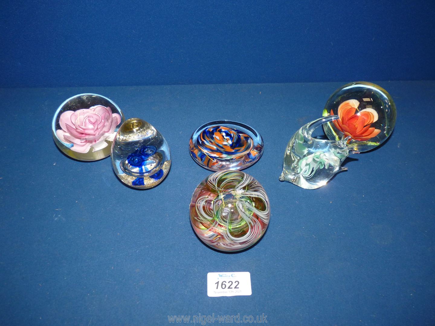 Six assorted paperweights to include; floral pattern, fish, etc.