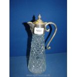 A Claret jug with white metal top.