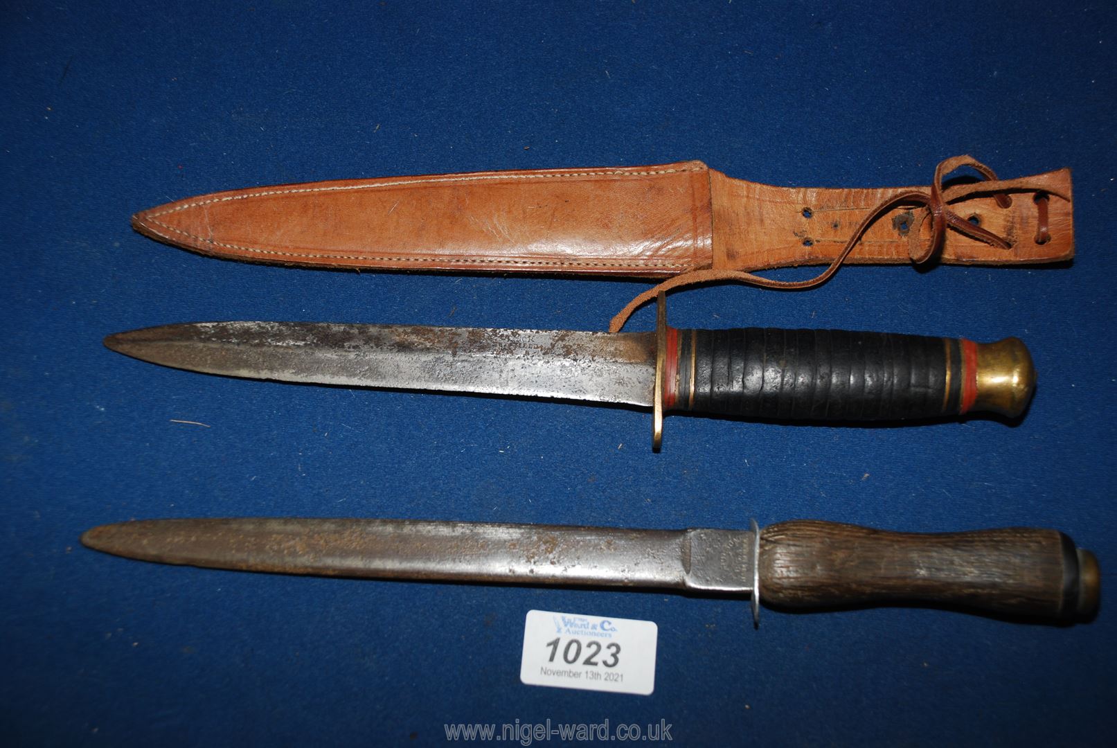 Two vintage daggers; one made in the USA by Nicholson 11 1/2" long and indistinctly signed,