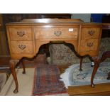 A 1940's/50's Oak and Walnut Dressing Table standing on cabriole legs with shell carved knees and