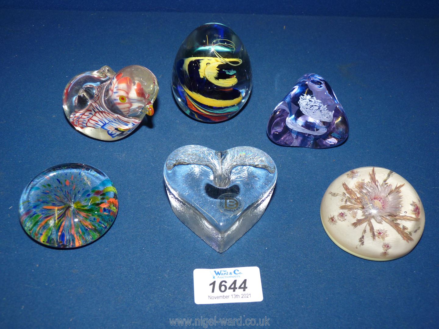 Six paperweights including Dartington heart shape, Caithness, pebbles,