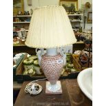 One orange patterned china lamp with shade.