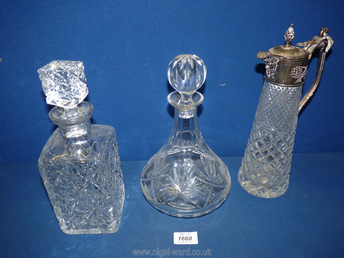 A white metal top Claret jug, plus two other decanters (one decanter with repair to rim).