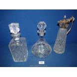 A white metal top Claret jug, plus two other decanters (one decanter with repair to rim).