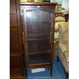 A floor standing Mahogany Display Cabinet standing on square legs with spade feet and having Gothic
