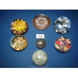 Seven assorted paperweights to include; glass diamond, stone, resin with flowers, etc.