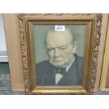 A framed print of Winston Churchill taken from a 1940's magazine.