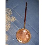 A copper warming pan.