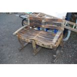 Two seater garden rocking bench made from old Whiskey barrels.