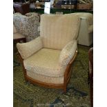 A stylish Ercol Elm wood framed 'Renaissance' easy Armchair, having beige shadow cushions, model no.
