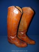 A pair of tan leather knee high Boots, size 9.