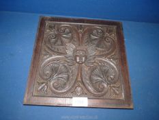 A carved Panel with embossed heart shapes and face to the centre, 11'' square.