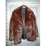 A dark fur Jacket with long revere collar, ruffle to lining at collar, size 14.