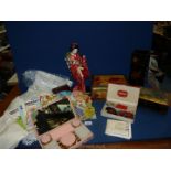 A quantity of miscellanea including a Japanese doll, old tins, linen table mats and coasters,