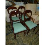 A set of four circa 1900 Mahogany framed balloon backed Dining Chairs having turned front legs,