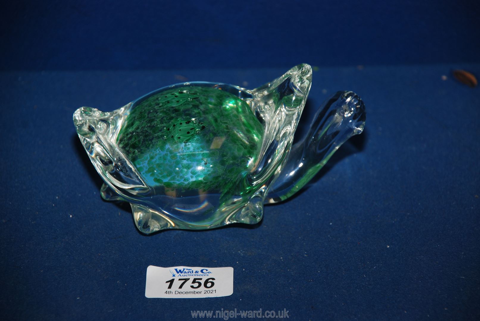 A green glass turtle paperweight.