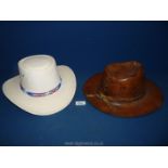 A tan tooled leather cowboy Hat and a Western Express Inc. cream felt covered Hat, USA size 6 7/2.