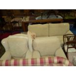 A beige upholstered three piece Lounge Suite comprising three seater settee and two armchairs.
