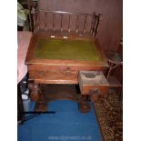 A circa 1900 Pine and other woods slope-topped Writing Desk having a gold tooled green leather