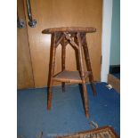 An octagonal cane conservatory table, having a lower shelf,