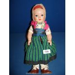 A vintage Doll in costume dress, with sleeping eyes and marked 'Sonni' to the back of her head,