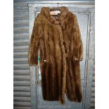A Beaver Lamb coat by Swears and Wells in pale brown shade with two large covered buttons,