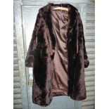 A dark Beaver Lamb coat, shawl collar, full length sleeves with cuff, size 14 approx.