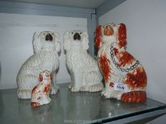 Four Mantle Spaniels, all with wear and crazing including two matching white,