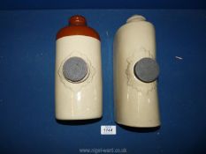 Two earthenware hot water bottles.