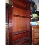 A Mahogany set of floorstanding Bookshelves with four adjustable and two fixed shelves and a dentil