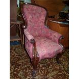 A Mahogany show frame buttonback easy Chair standing on scroll front legs and re-upholstered in