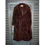 A brown Ponyskin coat by Basden & Martin of Cheltenham, shawl collar, 3/4 length sleeves with cuffs,