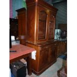 A circa 1900 Mahogany Bookcase over a cupboard base having two frieze drawers and by ''H.