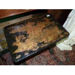 An appealing black lacquered Chinoiserie work Table decorated in gold with lakes,