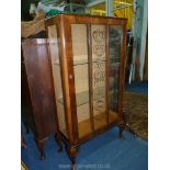 A Mahogany and Walnut finished China Display Cabinet standing on brief cabriole legs,