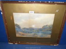 A framed and mounted watercolour depicting a rural landscape with trees and rolling hills in the