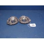 A pair of silver heart shaped Bonbon dishes with pierced decoration on ball feet, maker Colin Hewer,