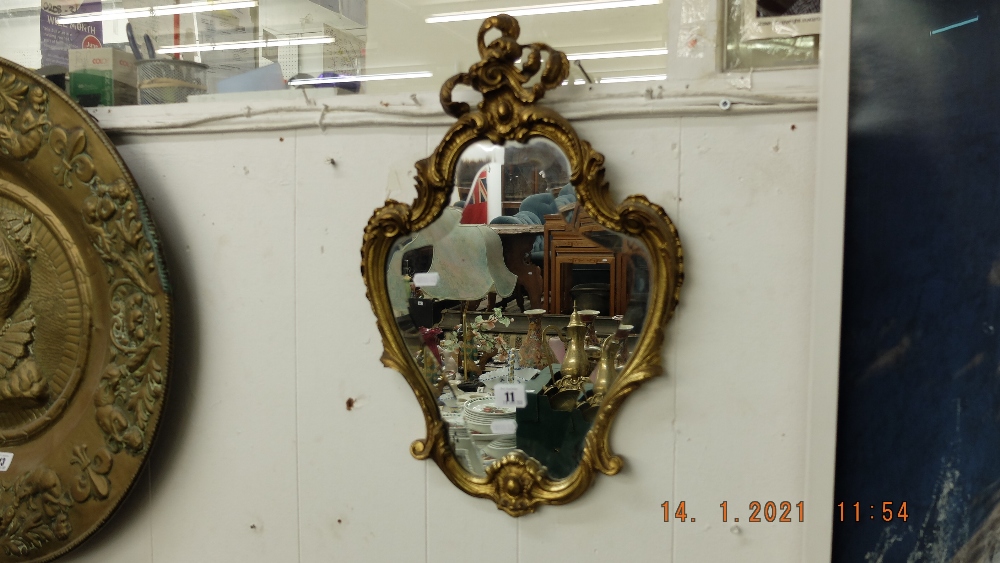 A decorative brass framed mirror