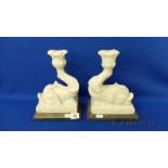 A pair of marble Dolphin candlesticks