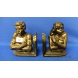 A pair of bronze African bookends