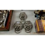 Three silvered lions head door knockers