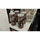 Four Imari style cylindrical vases