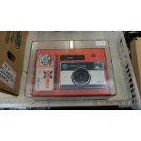 A Kodak boxed Instamatic camera,