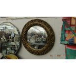 A circular gilt mirror