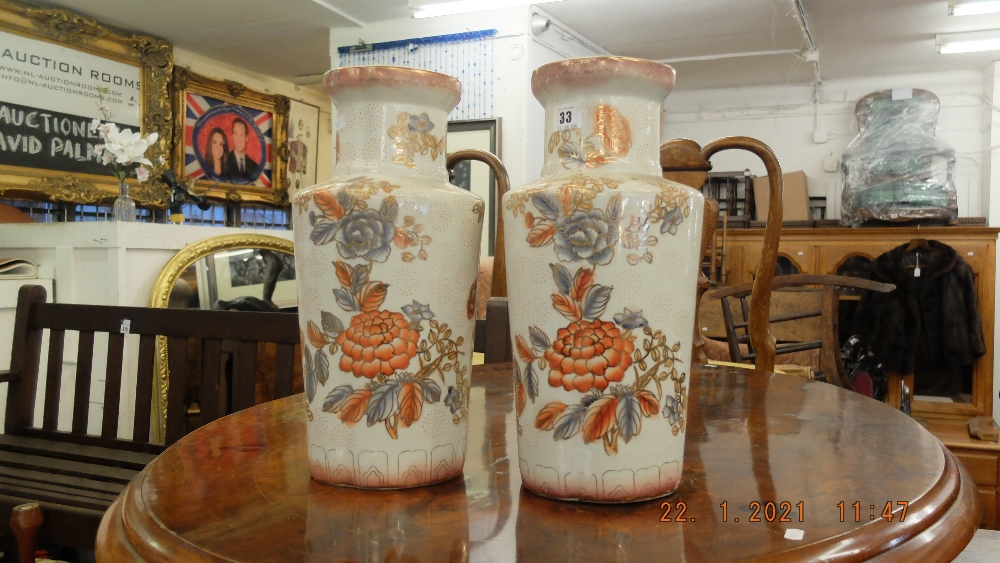 A pair of orange and white vases