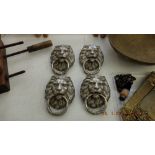 Four silvered Lions head door knockers