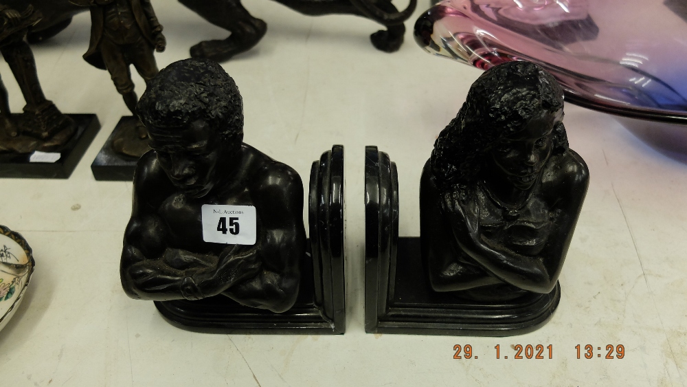 A pair of bronze African bookends