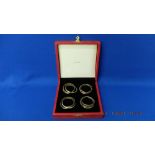 A set of four Trinity napkin rings in Original box by Cartier